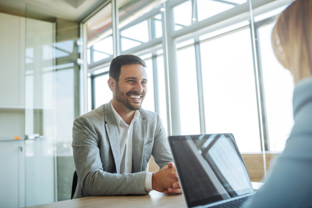 Young man smiling during a job interview